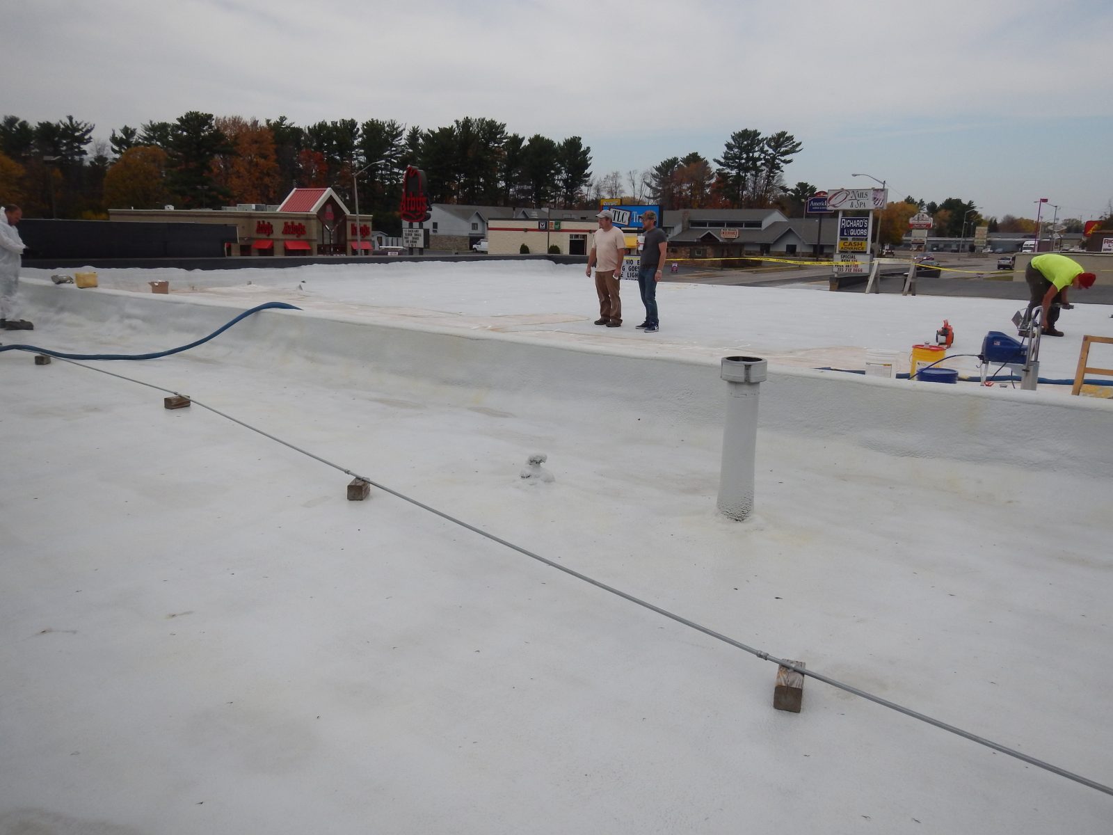 Metal roof sealed with bright reflective coating