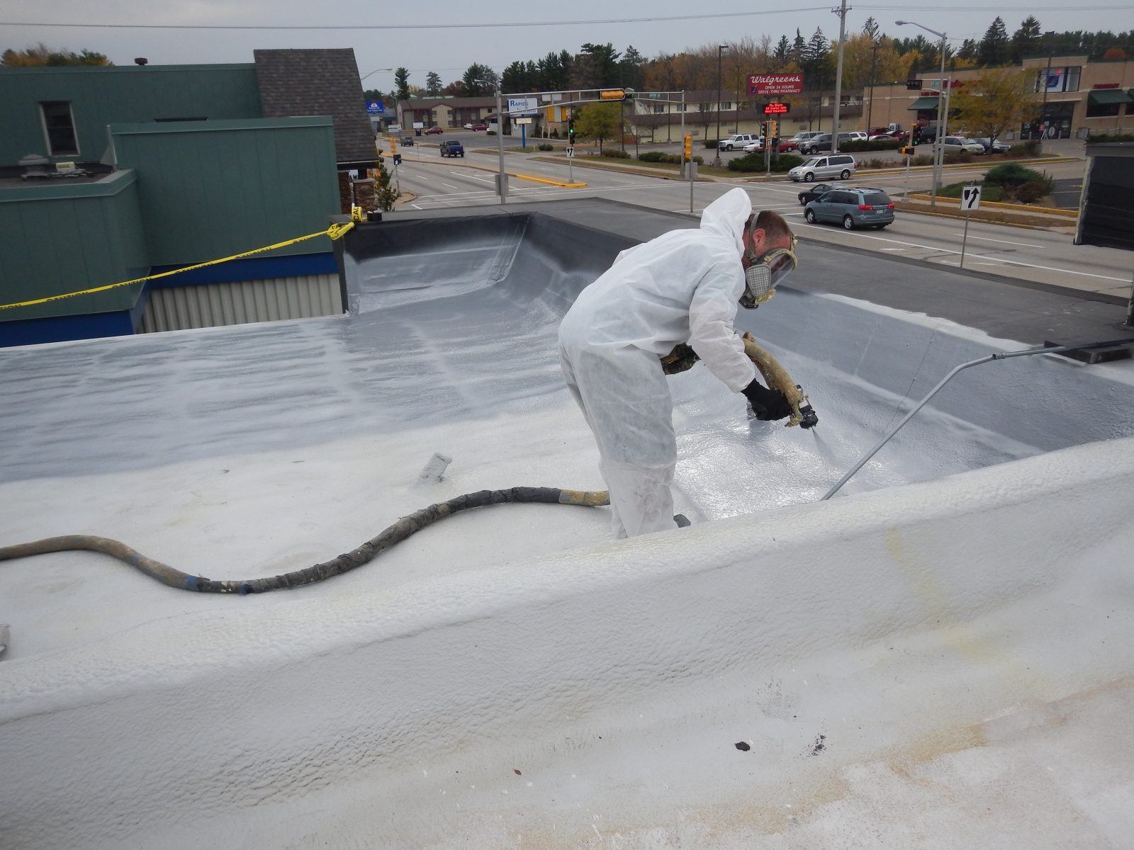 Bright reflective coating applied across a metal roof