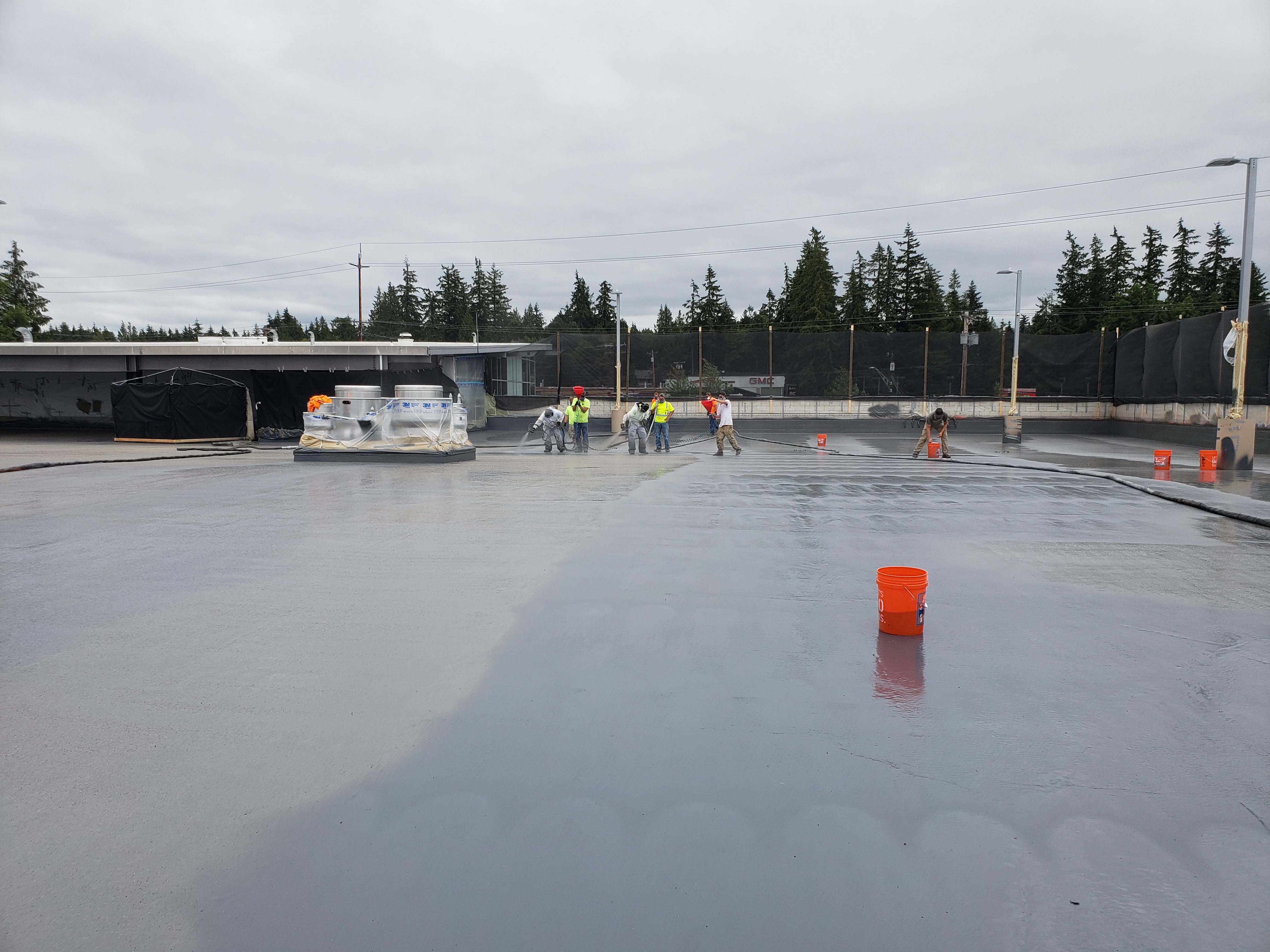 Aged rubber membrane roof being restored with a coating